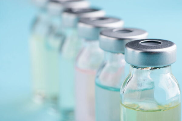 Macro view on vials. Different color of liquid medicine. Development of medications and vaccines.